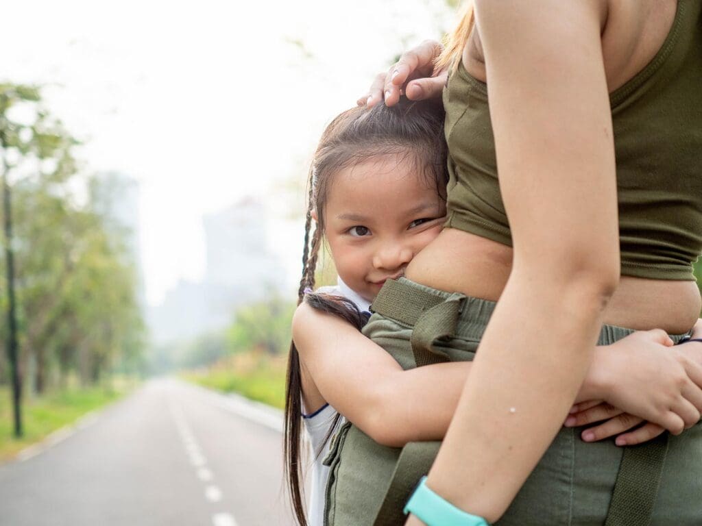 Young girl smiling and looking at the camera.